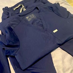 Figs navy blue scrubs, offering xsmall top with both flare and jogger pants. XST
